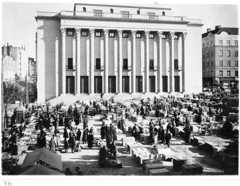 Konserthuset i Stockholm med pelarraden mot Hötorget och torghandel framför trappan, svartvitt fotografi
